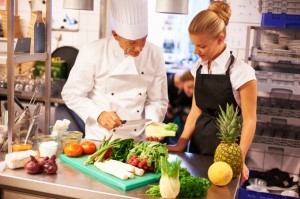 experienced chef giving culinary lessons to female trainees