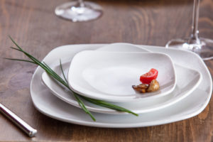 White plates on wooden table