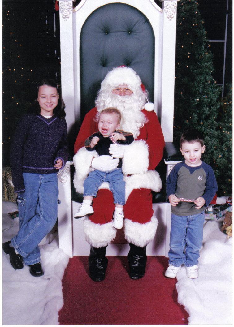 A child on Santa's lap crying