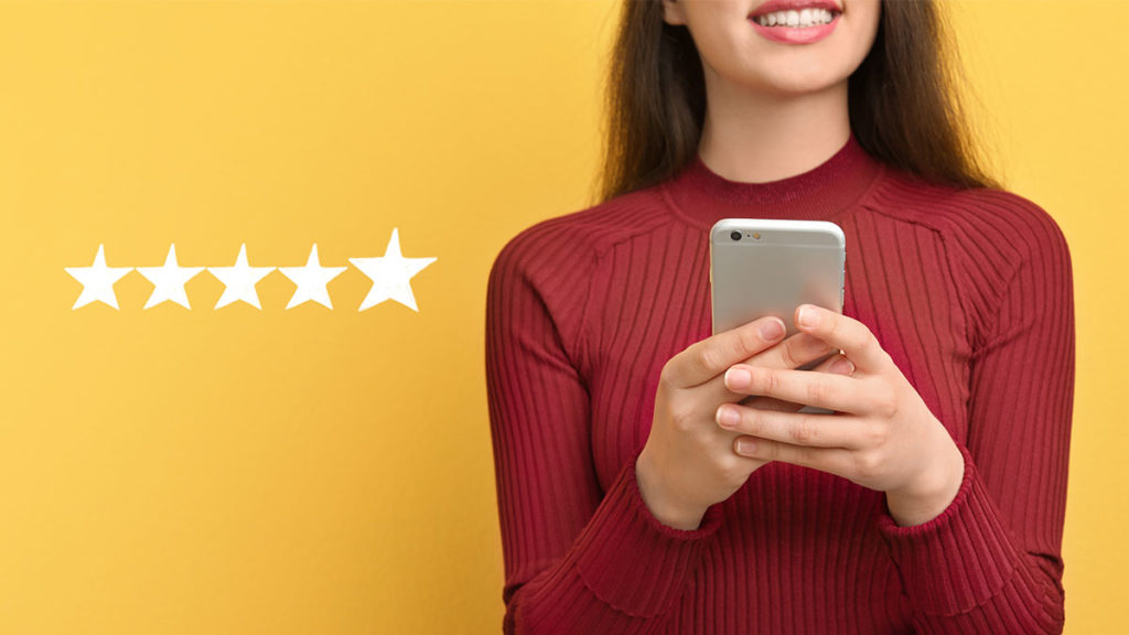 Woman giving restaurant review on mobile device