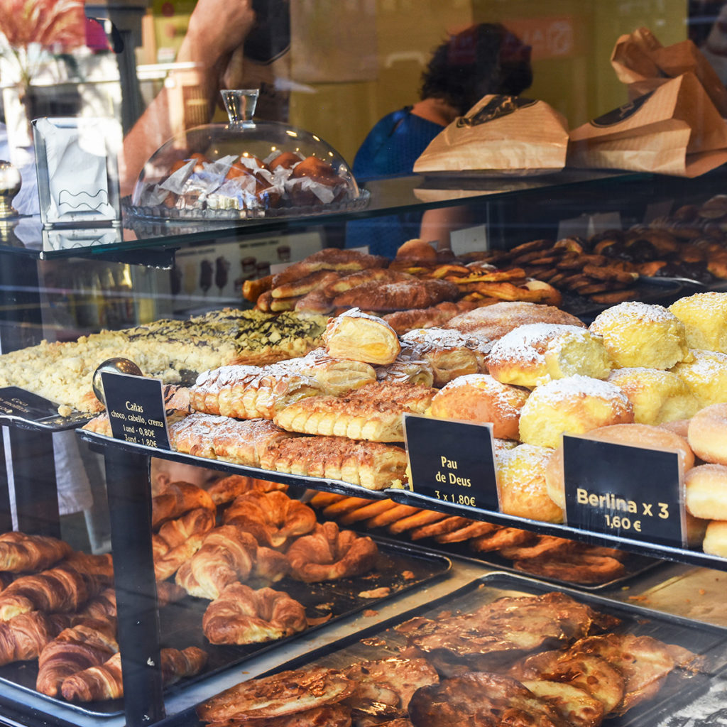 Bakery display with baked goods and pastry behind glass